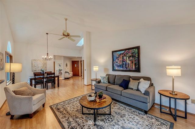 a living room with furniture a rug and a lamp
