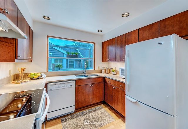a kitchen with a sink stove and refrigerator