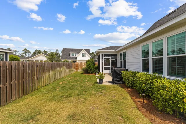 a bedroom with a large bed a chandelier and a window