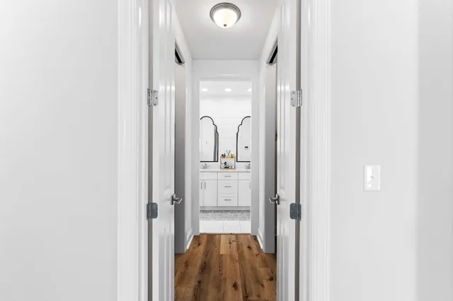 a living room with furniture a flat screen tv and a potted plant