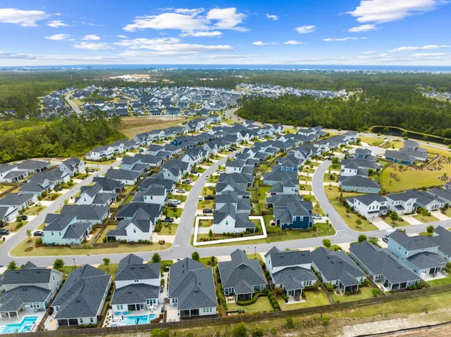 an aerial view of residential houses with outdoor space