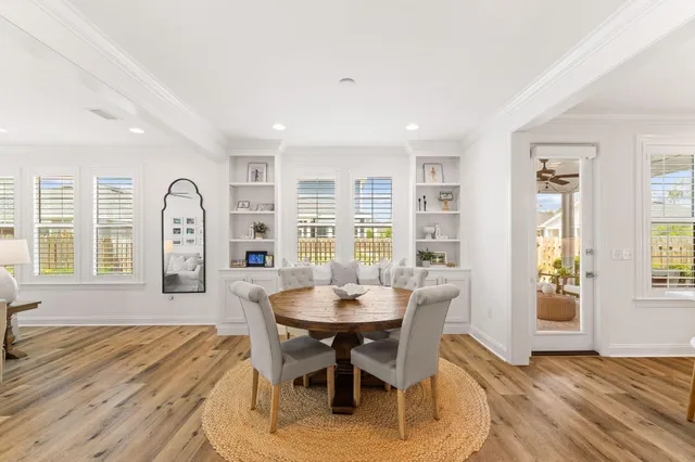 a kitchen with cabinets stainless steel appliances and wooden floor