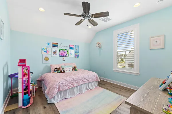 a bedroom with furniture and wooden floor