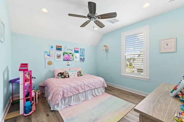 a bedroom with furniture and wooden floor