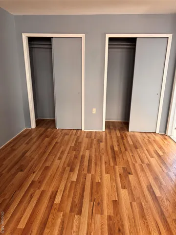 a bathroom with a granite countertop bathtub shower sink vanity and a toilet
