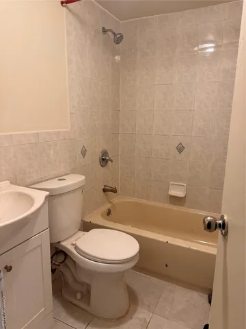 a bathroom with a toilet sink and shower