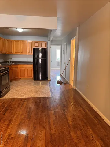 a view of a room with wooden floor