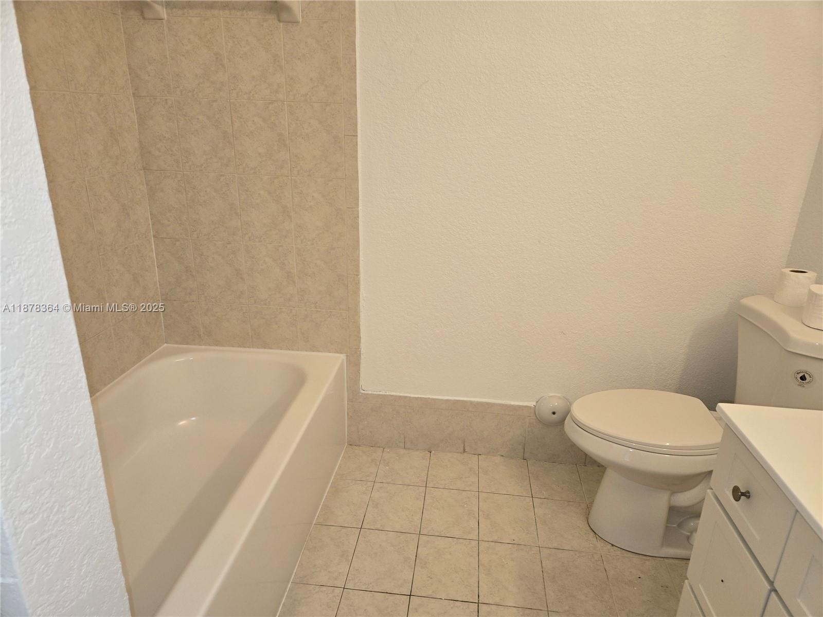 2903 Southeast 17th Avenue, Unit 111 Homestead, FL 33035 - Photo 11 of 15 a bathroom with a bathtub and toilet