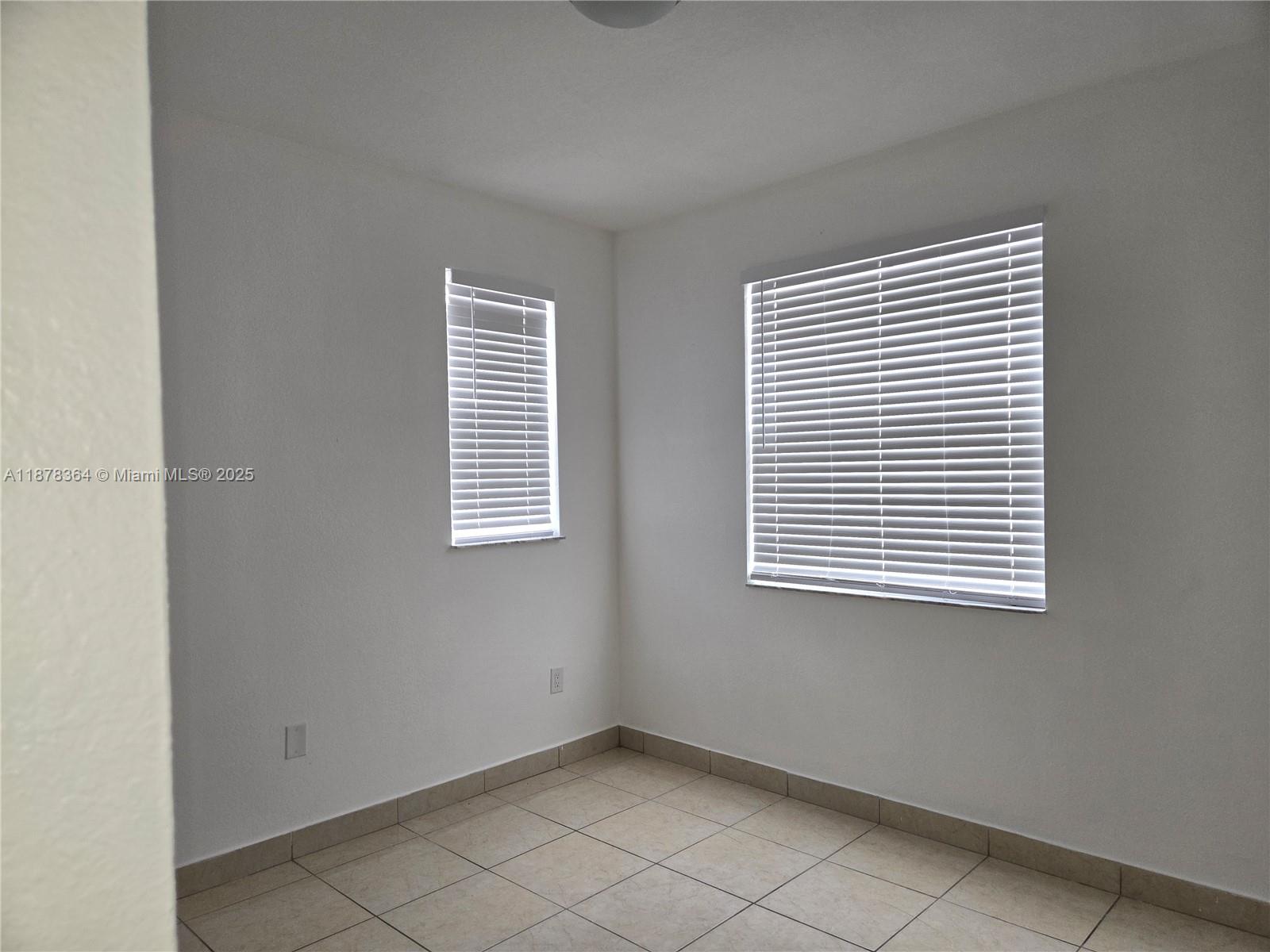 2903 Southeast 17th Avenue, Unit 111 Homestead, FL 33035 - Photo 4 of 15 an empty room with a window