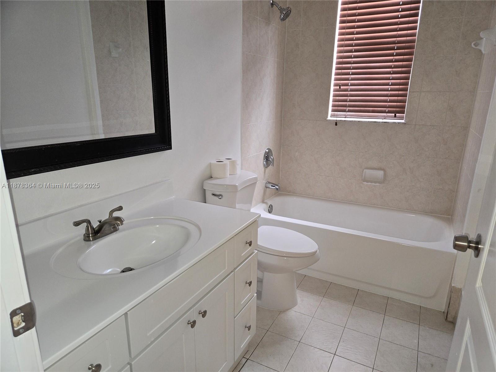 2903 Southeast 17th Avenue, Unit 111 Homestead, FL 33035 - Photo 6 of 15 a bathroom with a sink and a bathtub