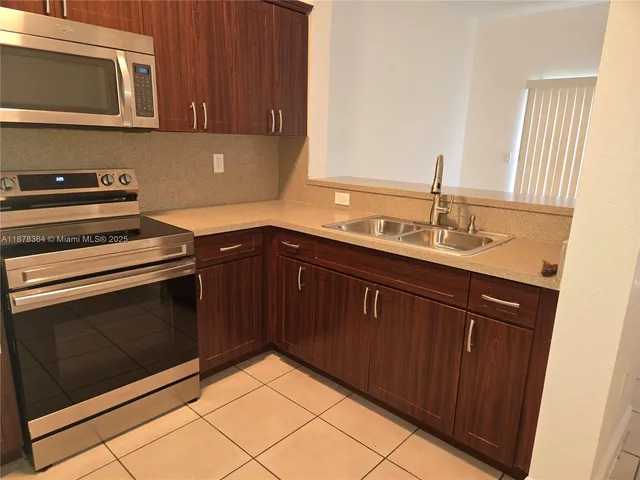 a kitchen with a sink stove and microwave