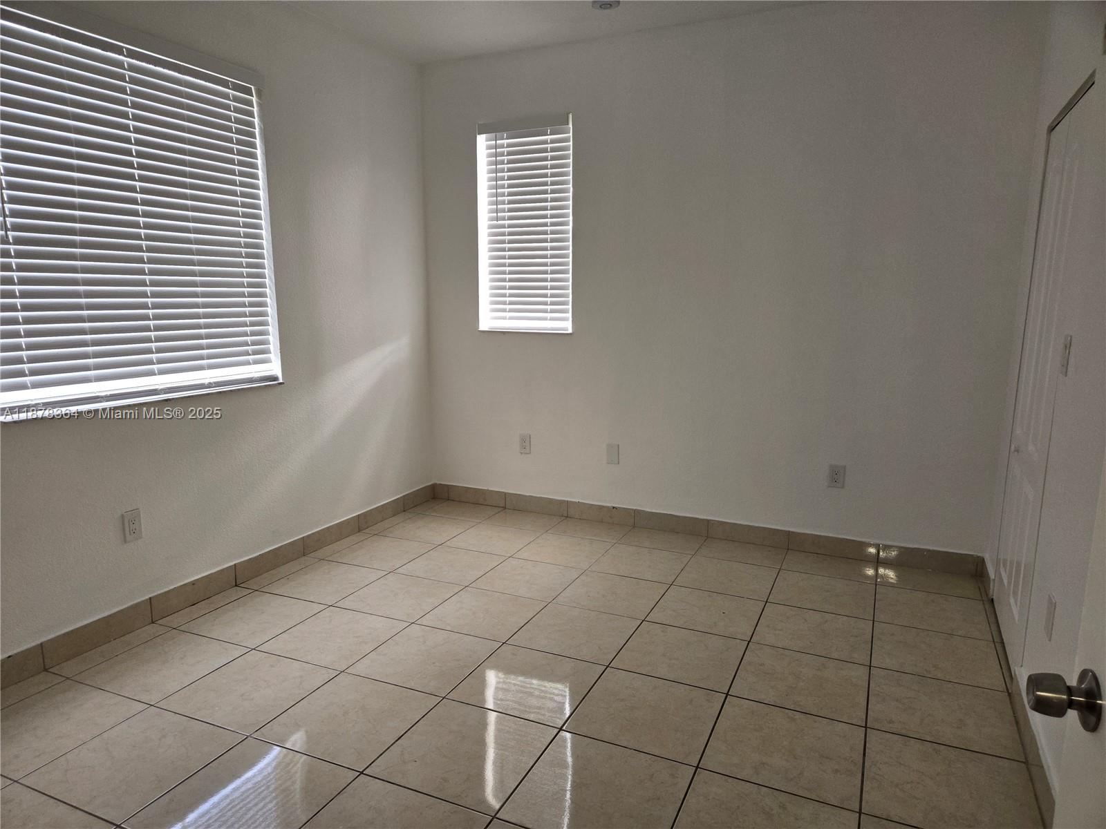 2903 Southeast 17th Avenue, Unit 111 Homestead, FL 33035 - Photo 10 of 15 an empty room with windows
