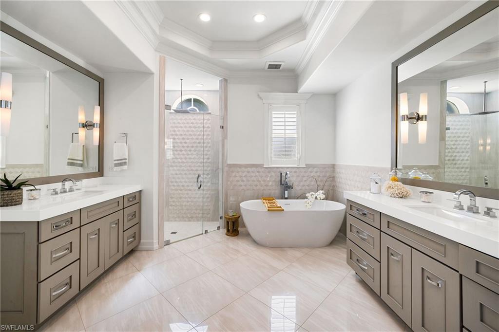 950 8th Street South Naples, FL 34102 - Photo 11 of 21 a spacious bathroom with a double vanity sink mirror double and bathtub