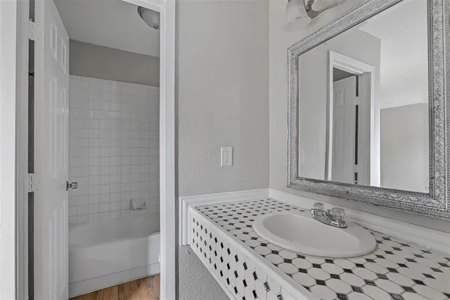 a bathroom with a sink and a mirror