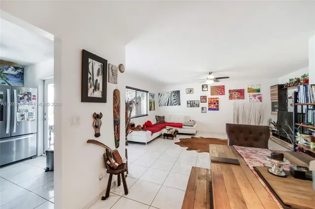 a kitchen with stainless steel appliances granite countertop a refrigerator a stove and a sink with wooden floor