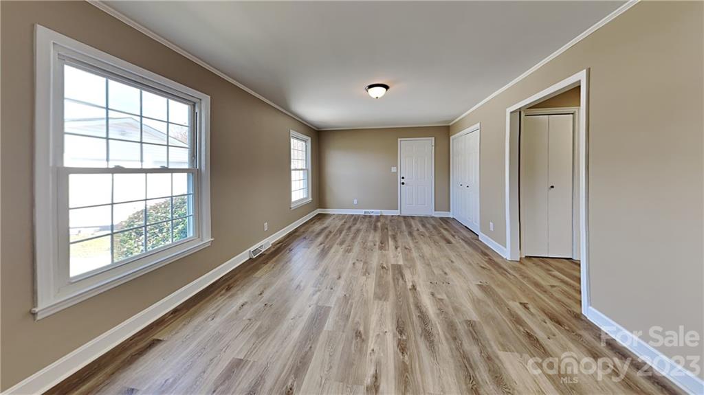 1209 Castlegate Drive Gastonia, NC 28054 - Photo 2 of 13 a view of wooden floor in an empty room with a window