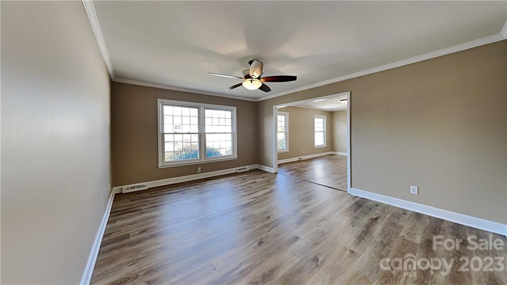 1209 Castlegate Drive Gastonia, NC 28054 - Photo 3 of 13 wooden floor in an empty room with a window