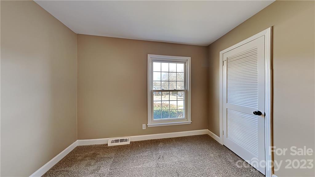 1209 Castlegate Drive Gastonia, NC 28054 - Photo 7 of 13 an empty room with windows