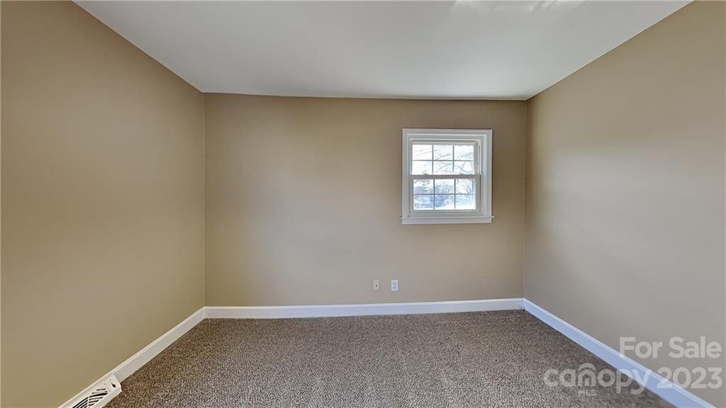 1209 Castlegate Drive Gastonia, NC 28054 - Photo 9 of 13 an empty room with windows