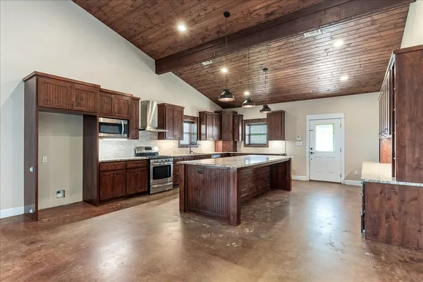 a large kitchen with stainless steel appliances kitchen island granite countertop a large counter top stainless steel appliances and cabinets