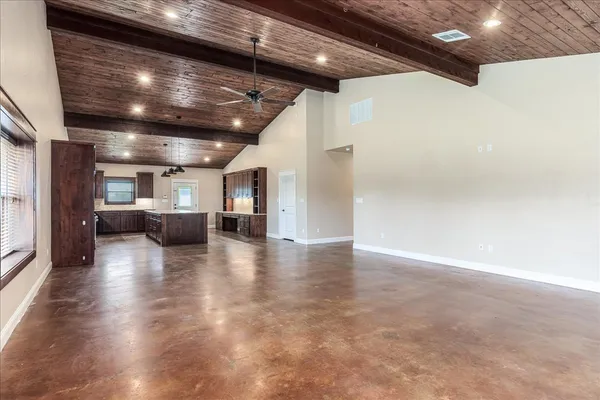 a view of a room with wooden floor