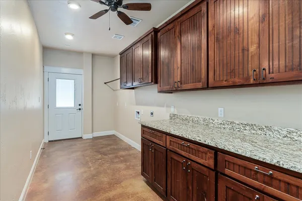 a kitchen with stainless steel appliances granite countertop wooden cabinets a sink and dishwasher
