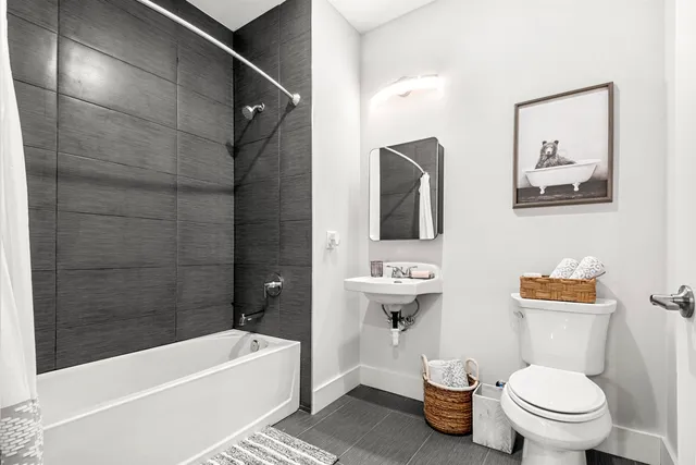 a bathroom with a toilet a sink and bathtub