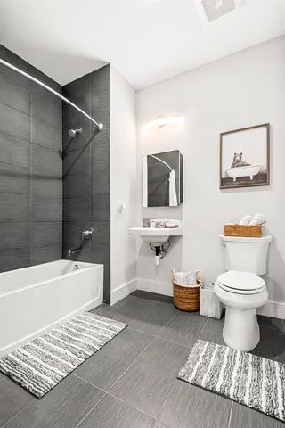 a bathroom with a toilet a sink and bathtub