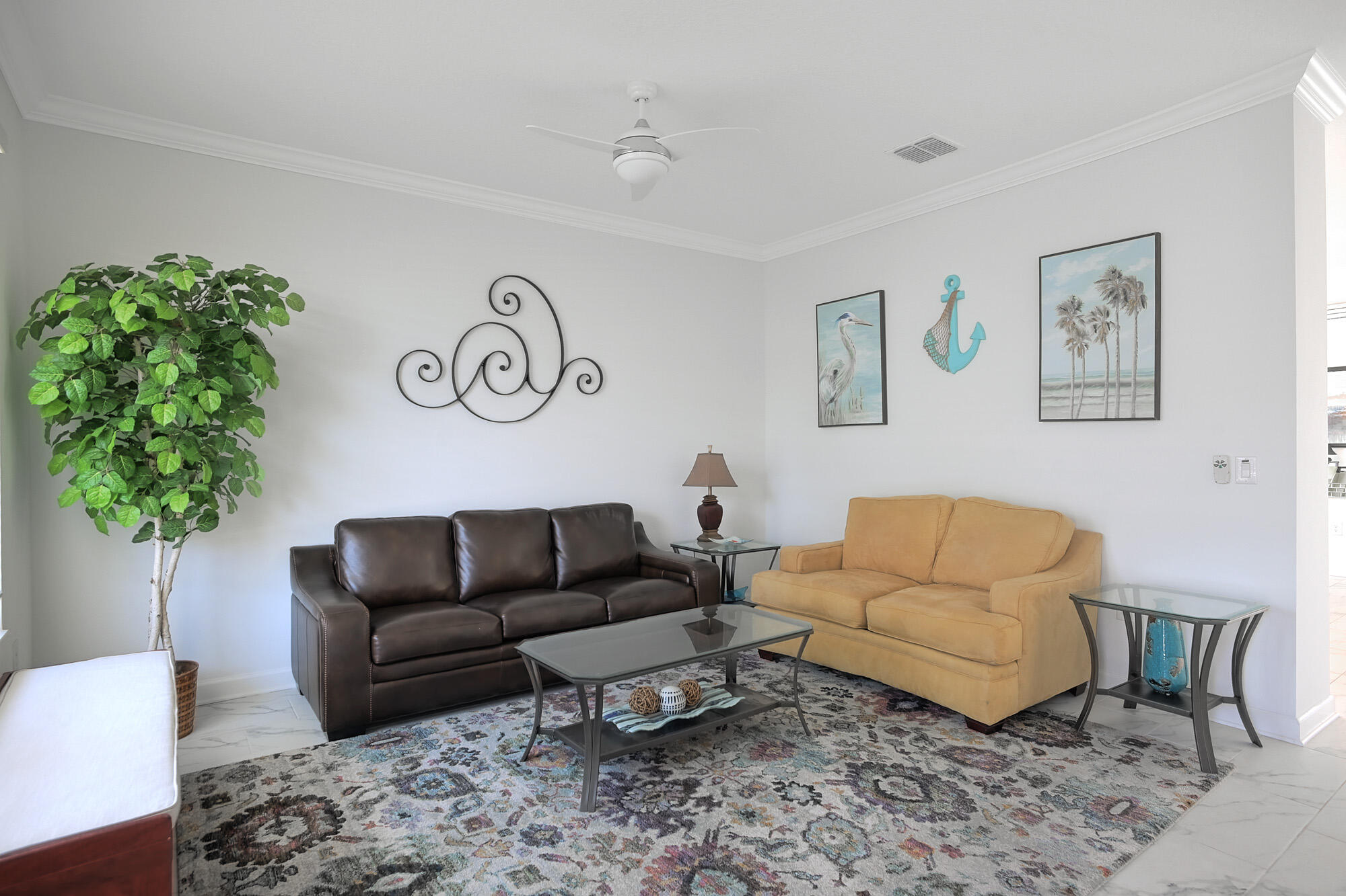 430 Strand Drive Melbourne Beach, FL 32951 - Photo 16 of 36 a living room with furniture and a potted plant