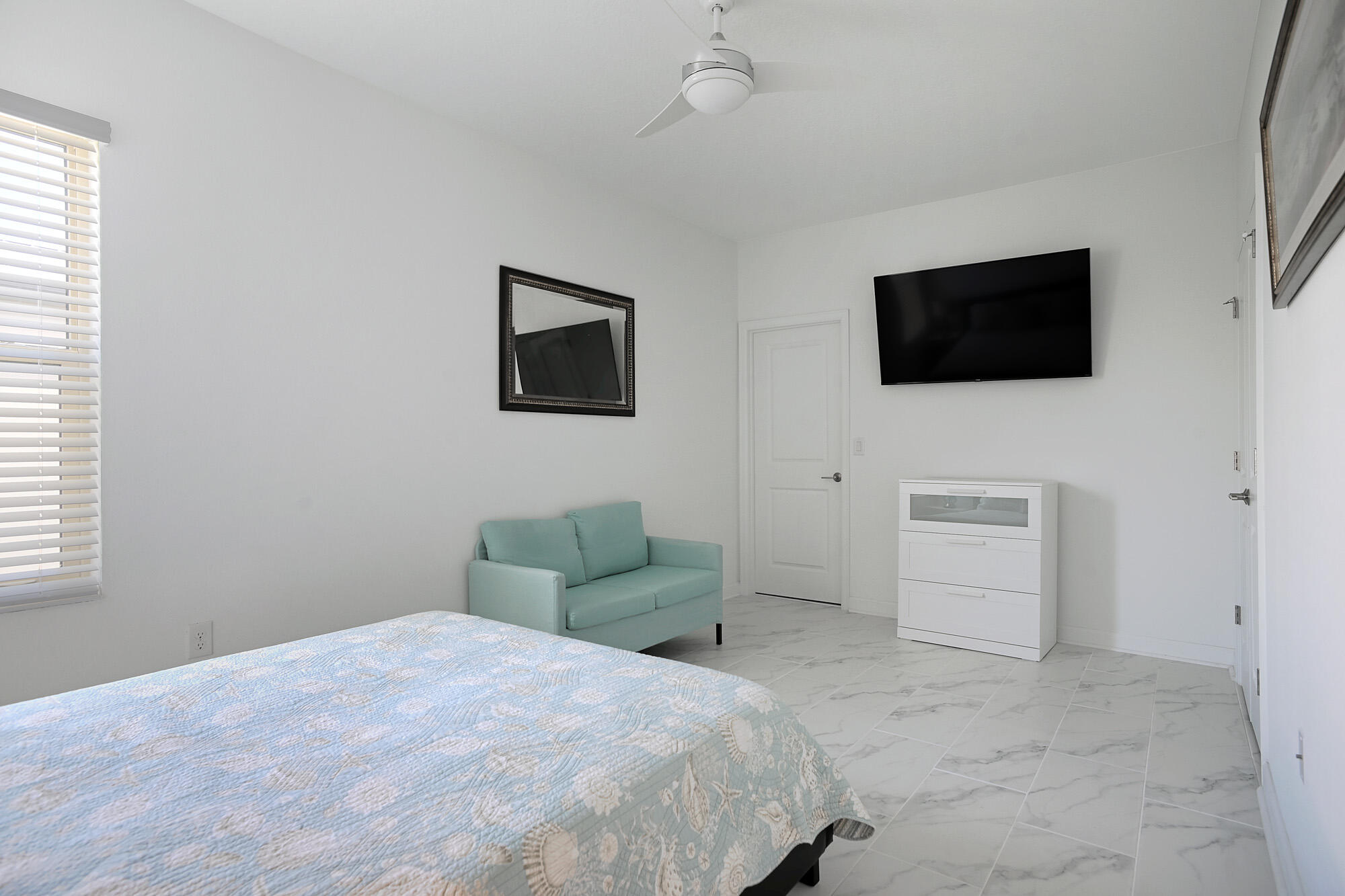 430 Strand Drive Melbourne Beach, FL 32951 - Photo 17 of 36 a bedroom with a bed and a flat screen tv