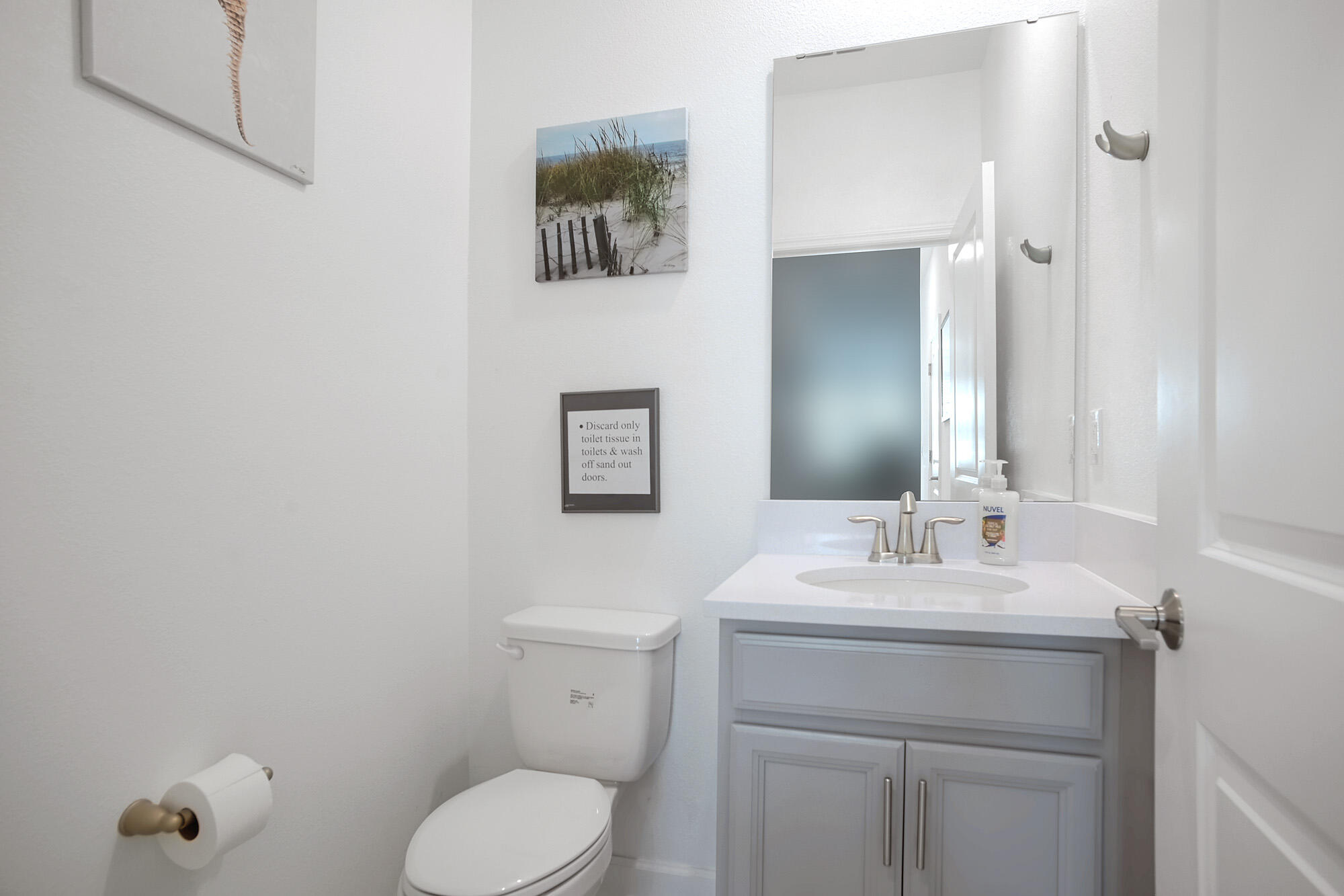 430 Strand Drive Melbourne Beach, FL 32951 - Photo 18 of 36 a bathroom with a toilet sink and mirror