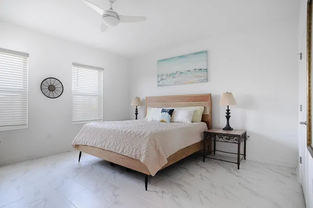 a living room with a couch and a potted plant