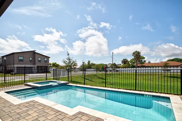 a kitchen with stainless steel appliances kitchen island granite countertop a refrigerator and a stove top oven