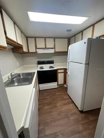 a kitchen with a refrigerator sink and stove