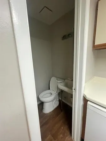 a bathroom with a toilet and a shower