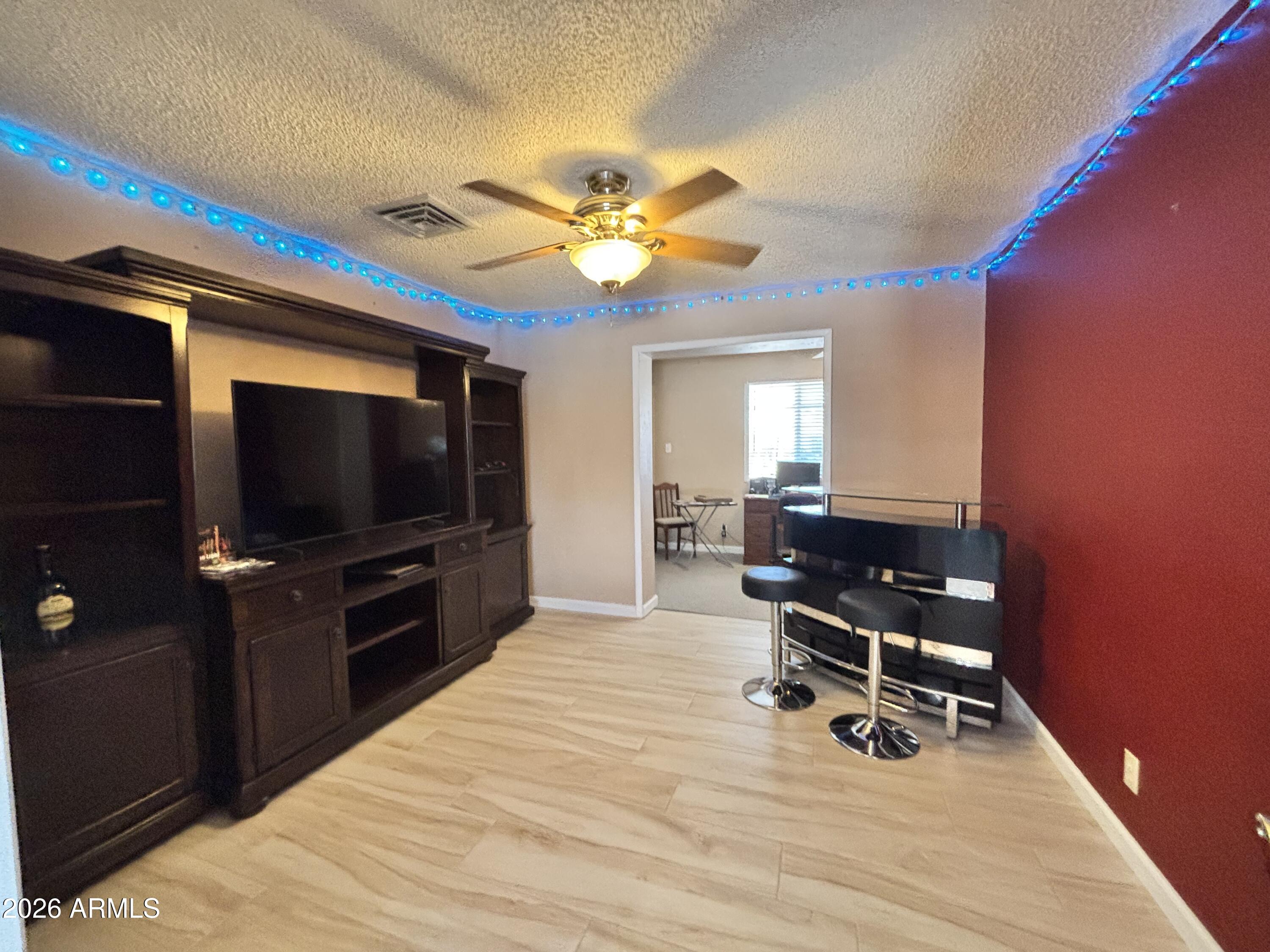 7745 East Mangun Road Mesa, AZ 85207 - Photo 33 of 35 a living room with furniture and a flat screen tv