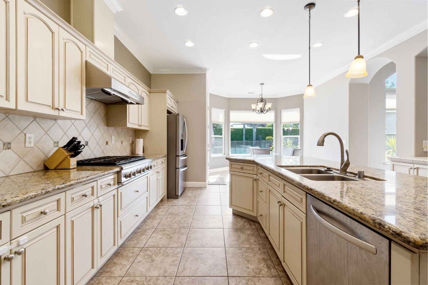 1847 Megan Avenue Clovis, CA 93619 - Photo 11 of 40 a kitchen with granite countertop a sink and a stove