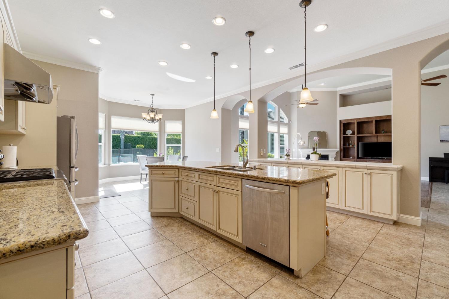 1847 Megan Avenue Clovis, CA 93619 - Photo 12 of 40 a large kitchen with granite countertop a large stove a sink and a refrigerator