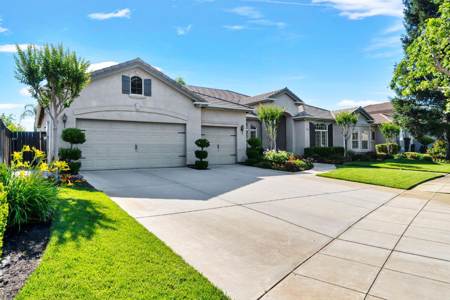 1847 Megan Avenue Clovis, CA 93619 - Photo 2 of 40 a front view of a house with a yard and potted plants