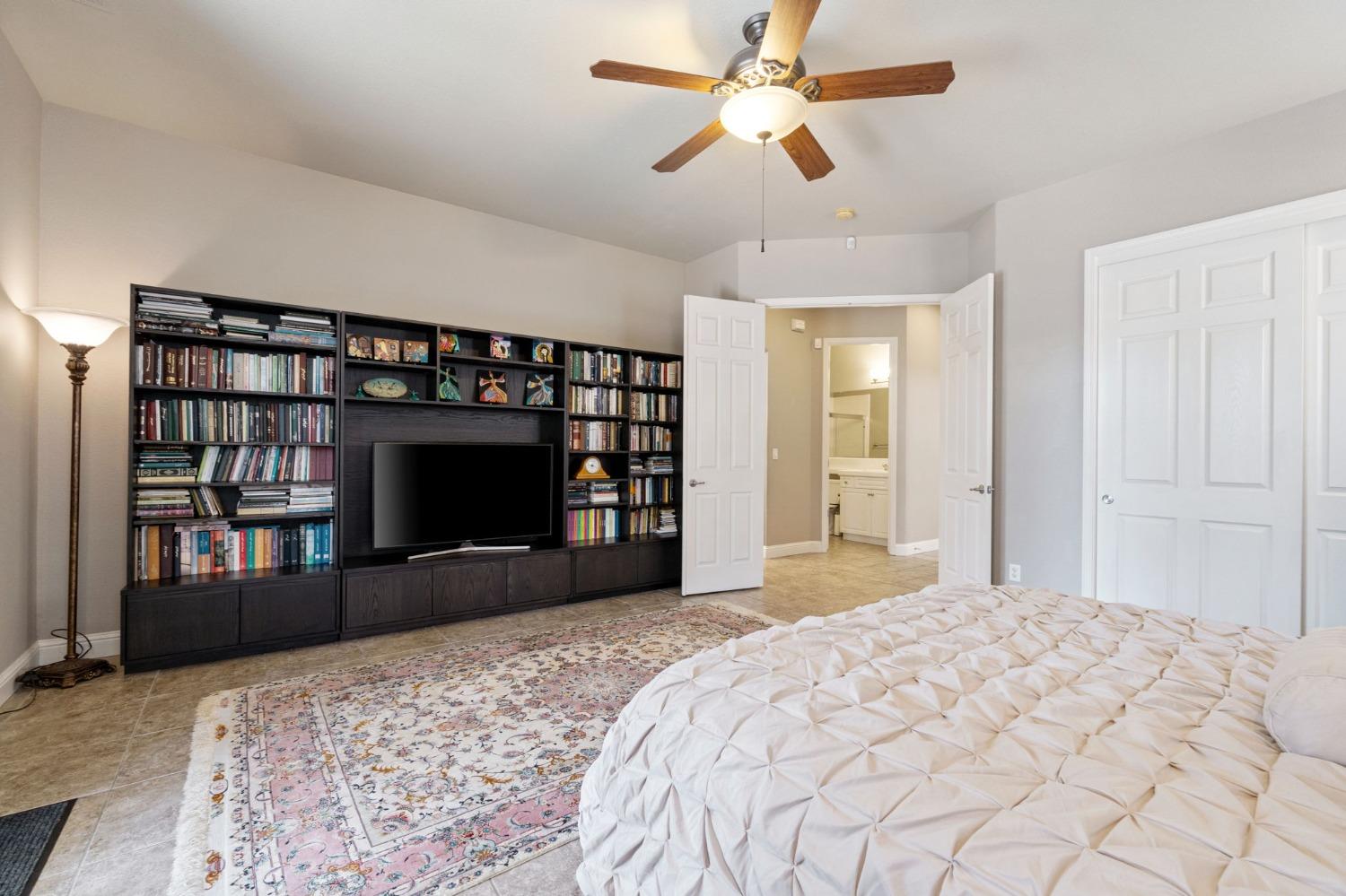 1847 Megan Avenue Clovis, CA 93619 - Photo 21 of 40 a bedroom with a bed and a fireplace