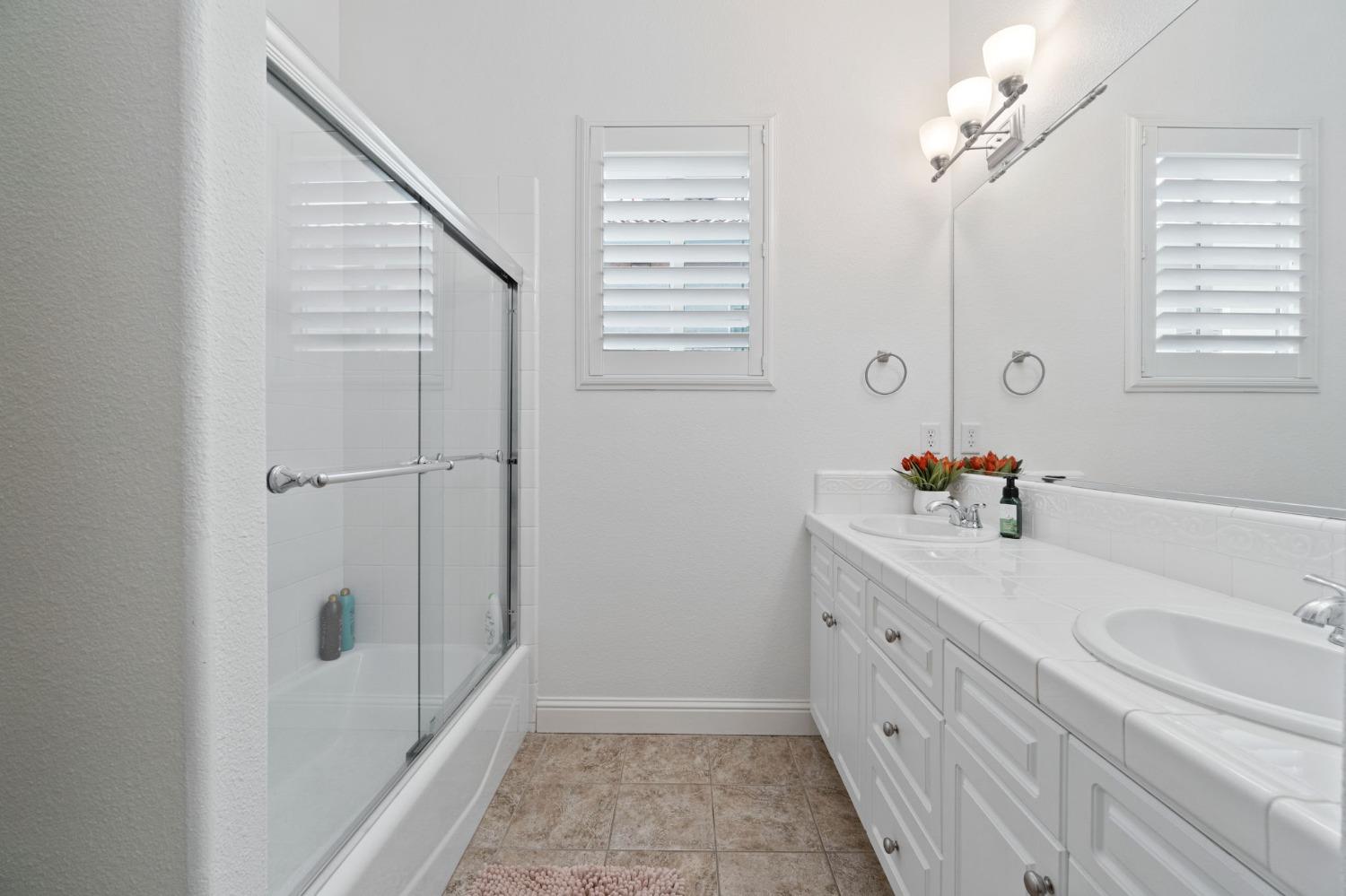 1847 Megan Avenue Clovis, CA 93619 - Photo 27 of 40 a bathroom with a tub sink and mirror