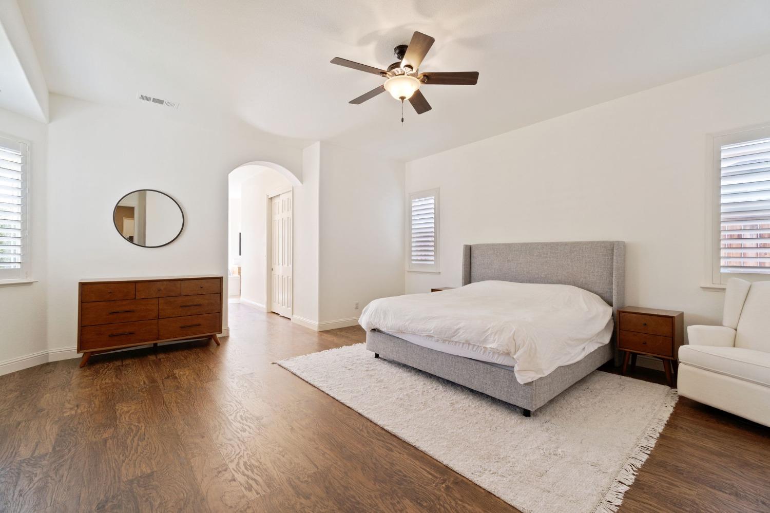 1847 Megan Avenue Clovis, CA 93619 - Photo 31 of 40 a bedroom with a bed a dresser and a chandelier