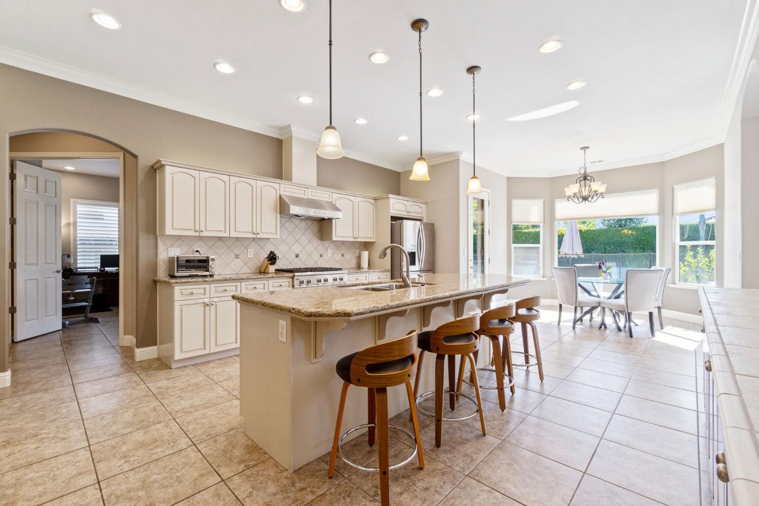 1847 Megan Avenue Clovis, CA 93619 - Photo 10 of 40 a large kitchen with a large counter top space a sink stainless steel appliances and cabinets
