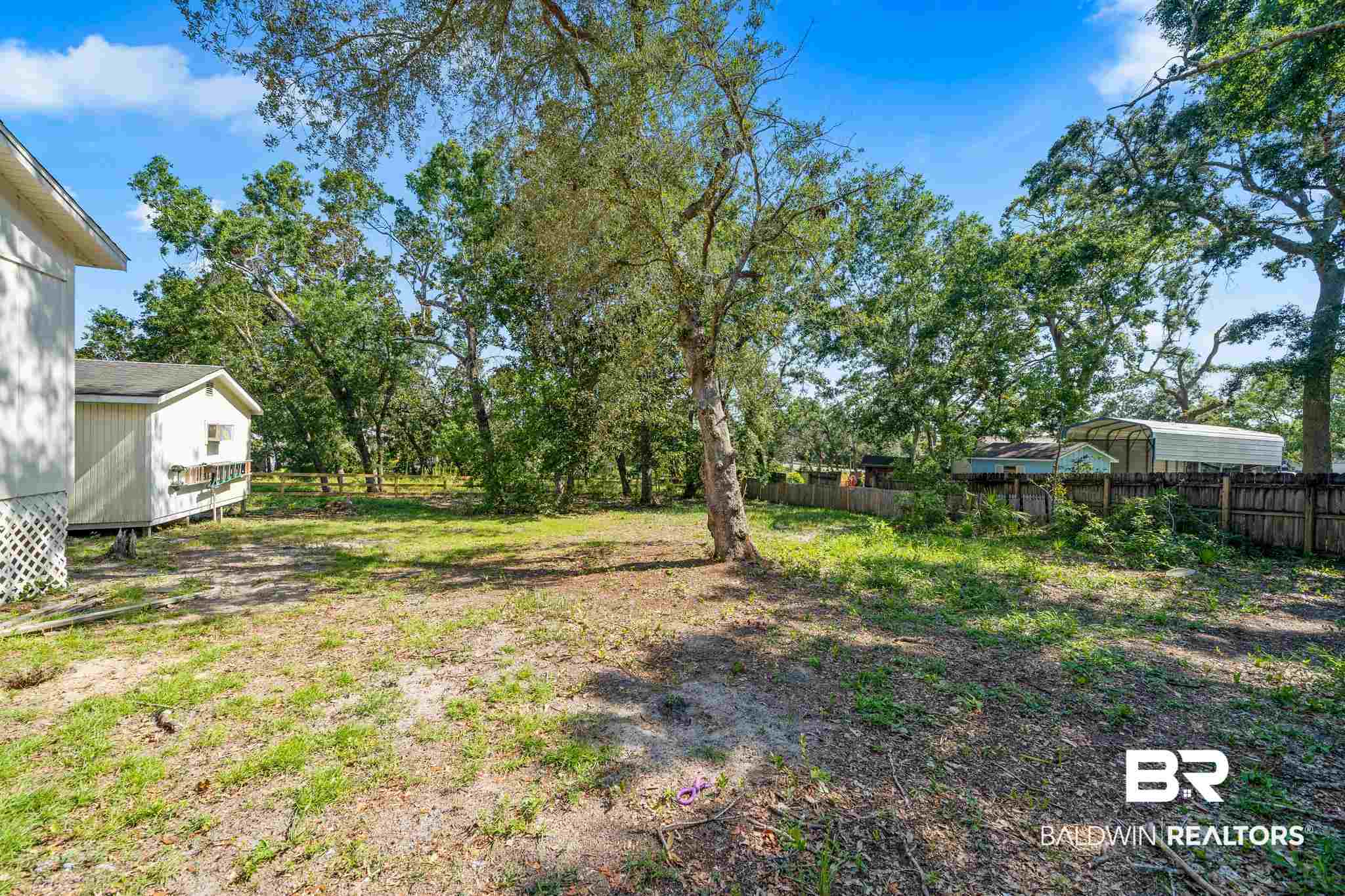 5424 Greentree Road Orange Beach, AL 36561 - Photo 6 of 33 Backyard fenced with several Trees