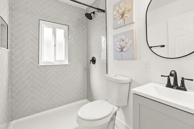 a bathroom with a toilet a sink and a mirror