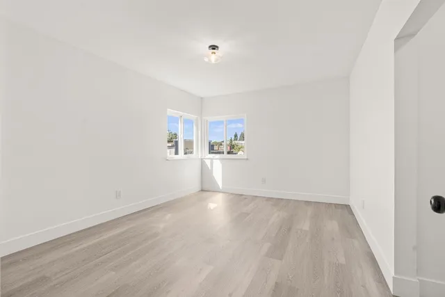 a view of a kitchen with wooden floor and a sink