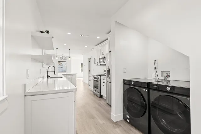 a kitchen with a sink a stove and a refrigerator