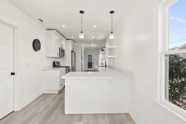 a view of kitchen with wooden floor