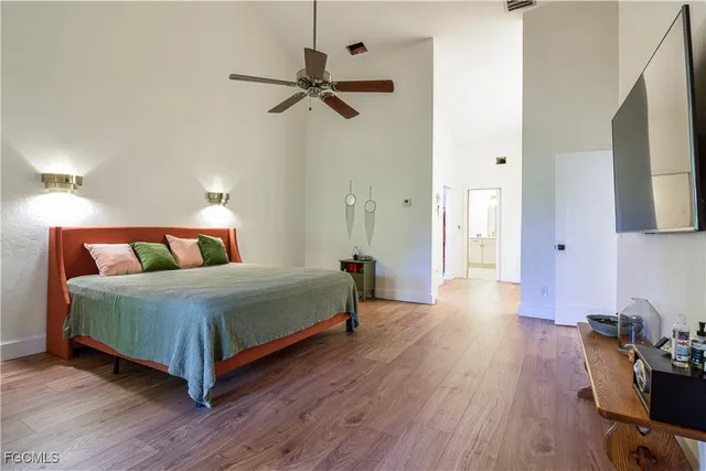 a bedroom with a bed and wooden floor