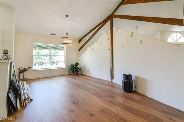 a living room with furniture a dining table and chairs